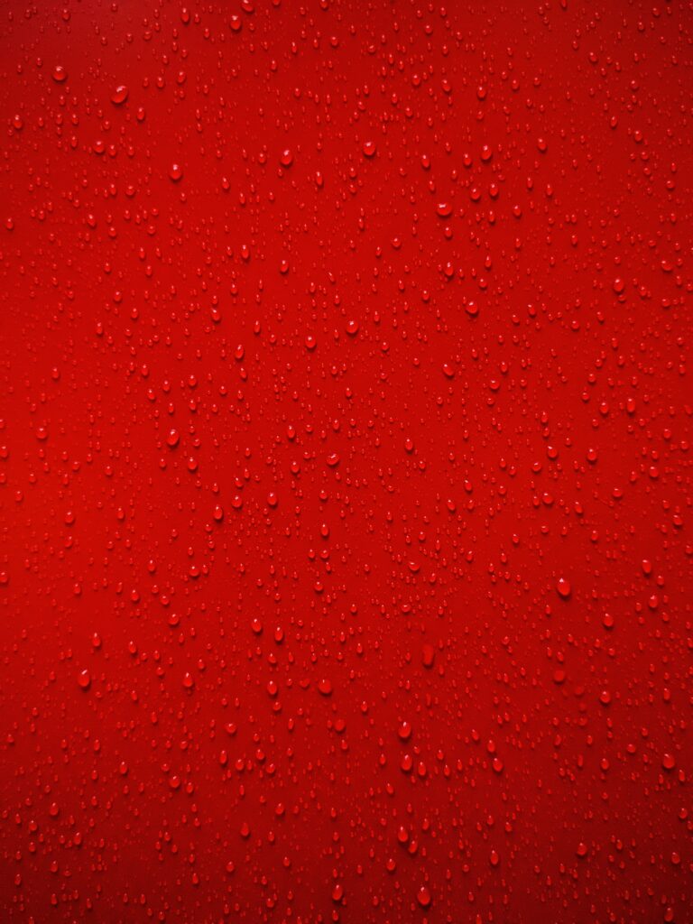 Vibrant Red Wallpaper: Macro Water Droplets on Glossy Surface