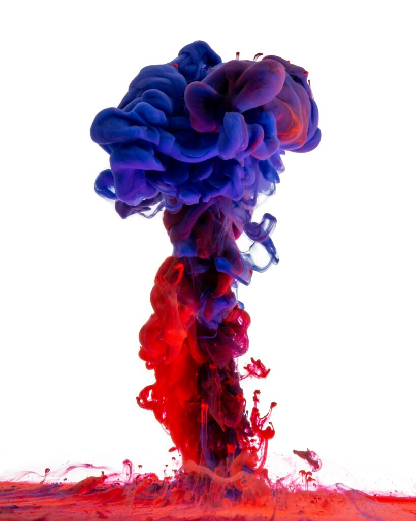 Vibrant Red & Blue Ink Clouds: Dynamic Macro Wallpaper Background