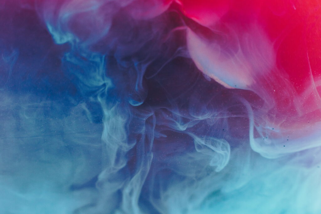 Colorful Chaos: Vibrant Red and Blue Smoke Bomb Creates Mesmerizing HD Wallpaper Background