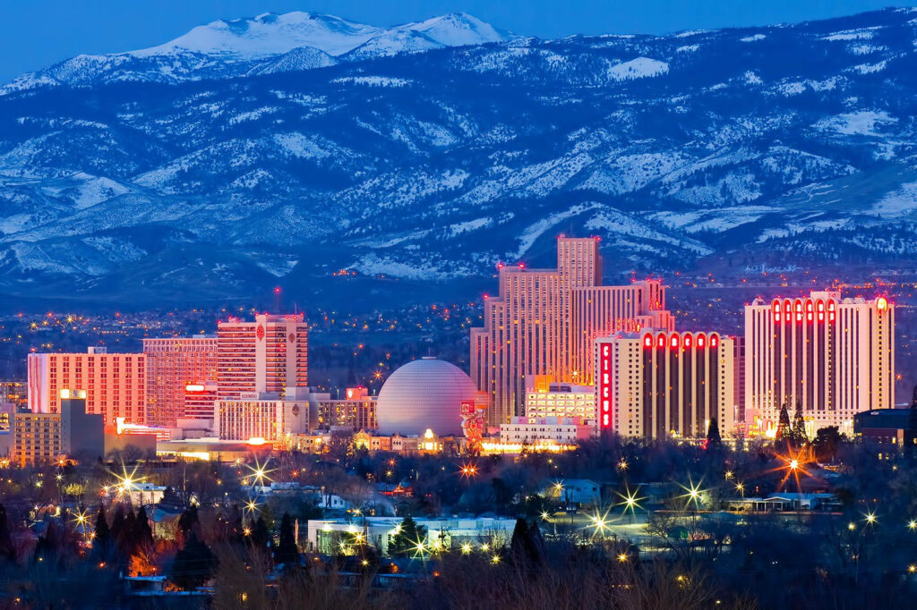 Vibrant Reno Cityscape Wallpaper: Illuminated Buildings & Mountain View