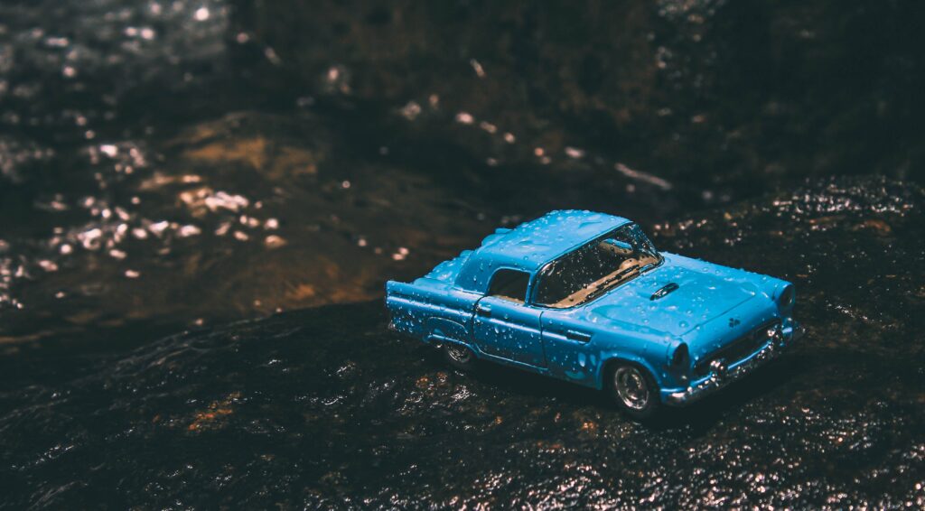 Retro Car Wallpaper: Detailed Toy Model on Textured Background