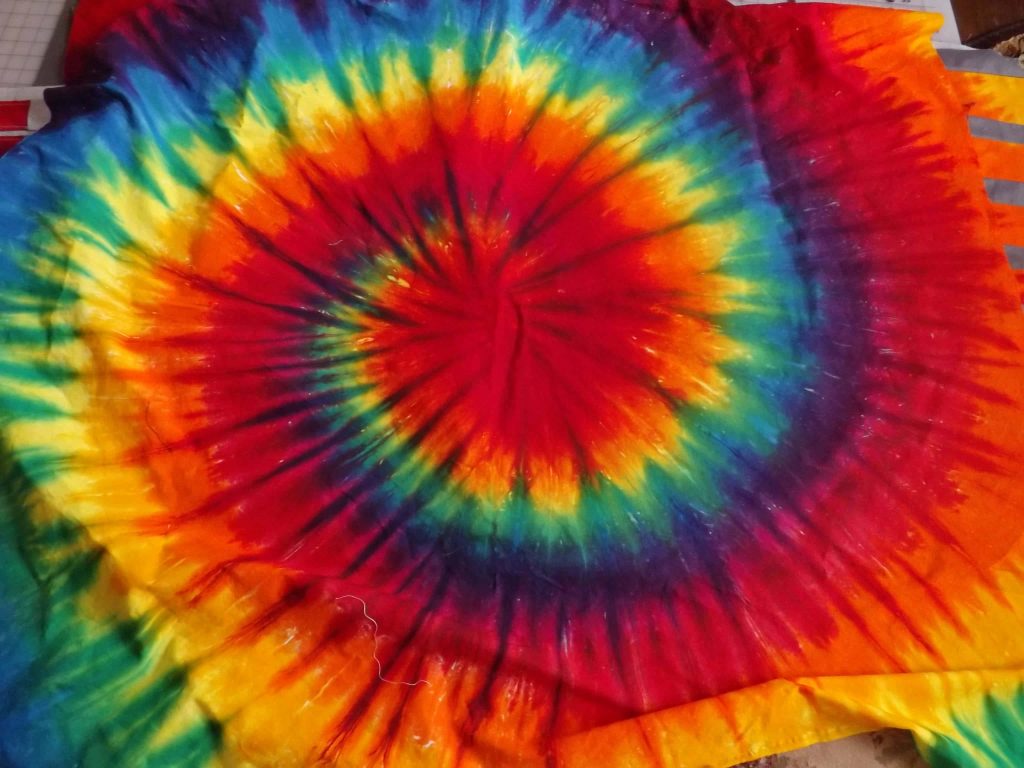 Bold rainbow tie dye spiral wallpaper vibrant psychedelic retro textile background