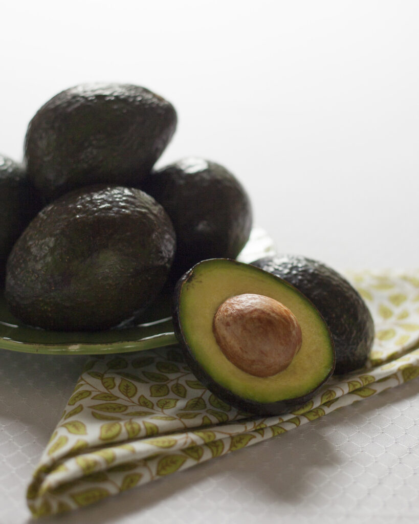 Fresh Avocado Display: Sliced with Green Flesh & Brown Seed Wallpaper