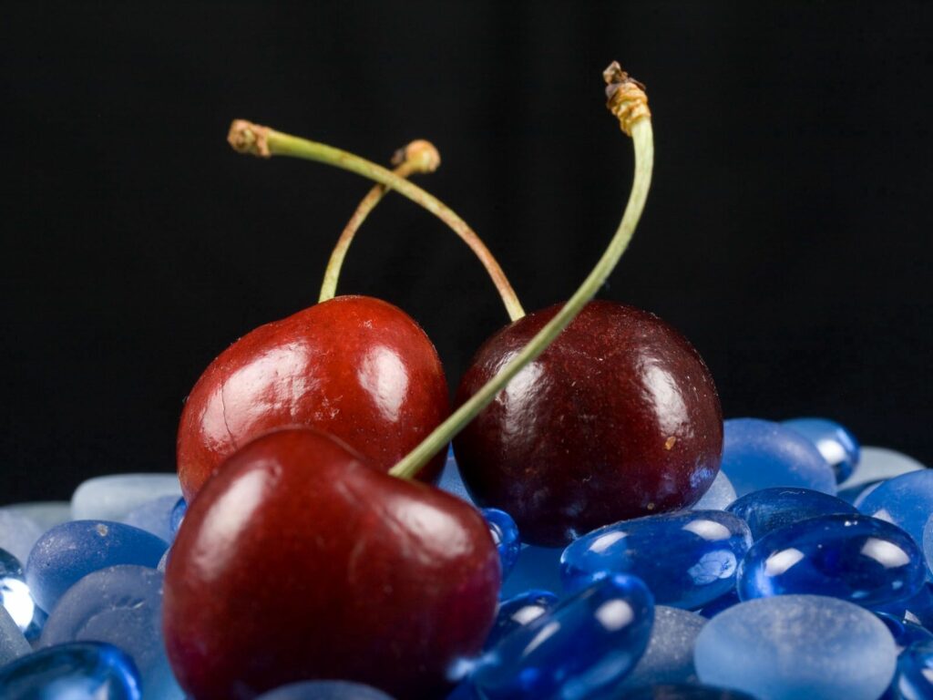 Vibrant Cherries on Blue Stones - Stunning Wallpaper Background
