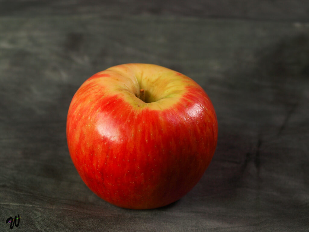 Vibrant Ripe Red Apple on Dark Textured Background - Stunning Wallpaper