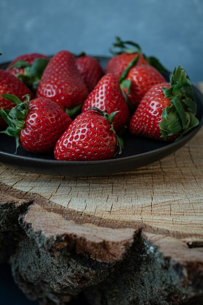 Vibrant Ripe Strawberries on Dark Plate - Rustic Wallpaper Background