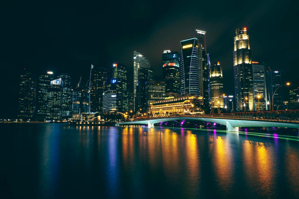 Vibrant Riverside Cityscape at Night - Colorful Wallpaper Background