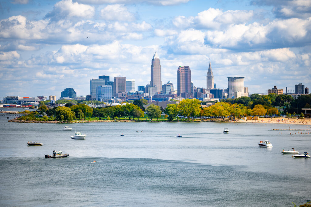 Vibrant Riverside Cityscape Wallpaper with Modern Buildings & Boats