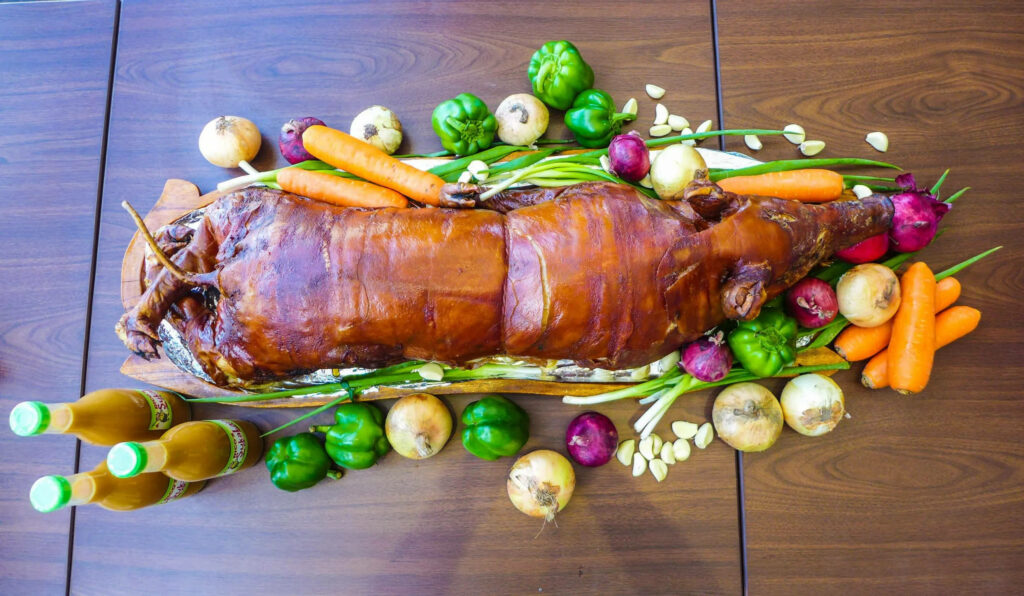 Vibrant Lechon Wallpaper with Fresh Vegetables on Wooden Table
