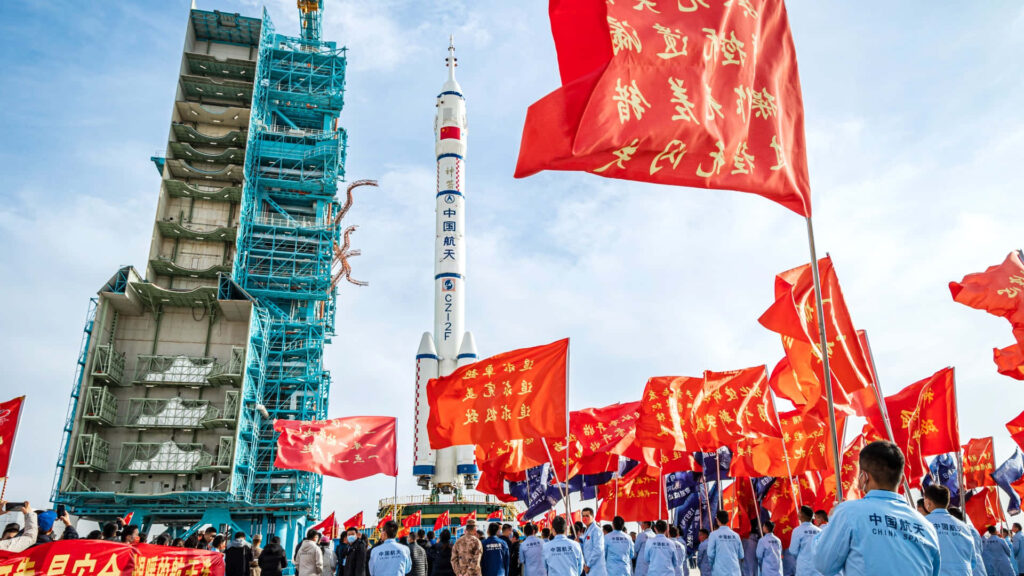 Vibrant Rocket Launch in China: Crowds & Red Flags in Clear Sky Wallpaper