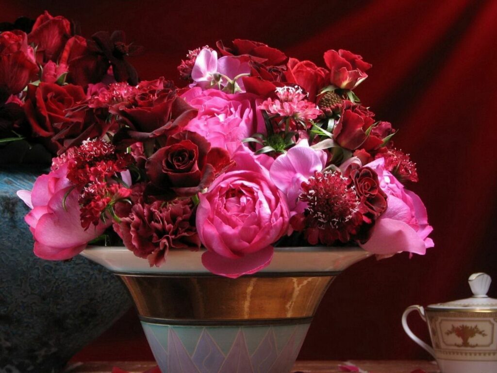 Vibrant Rose & Carnation Bouquet in Decorative Vase - Red Background Wallpaper