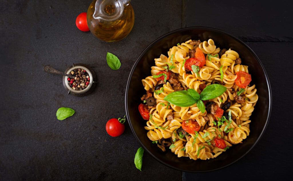 Vibrant Rotini Pasta Wallpaper with Basil & Cherry Tomatoes