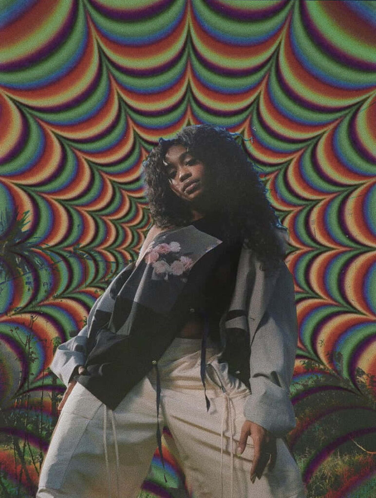 Vibrant SZA Wallpaper: Fashionable Pose with Psychedelic Backdrop