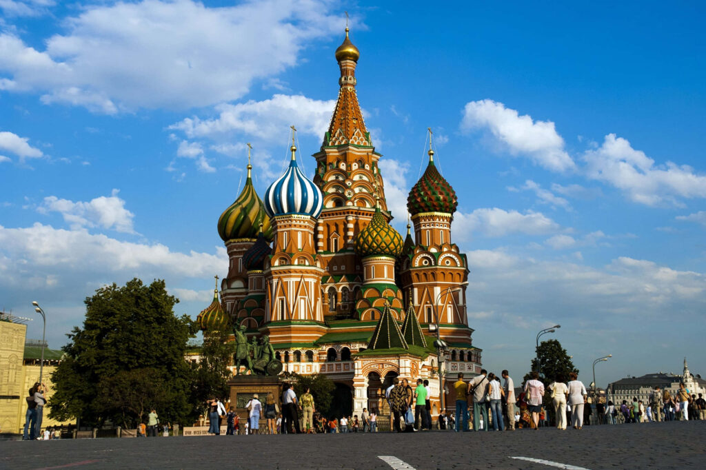 Saint Basils Cathedral Moscow vibrant colorful architecture with tourists under bright blue sky wallpaper