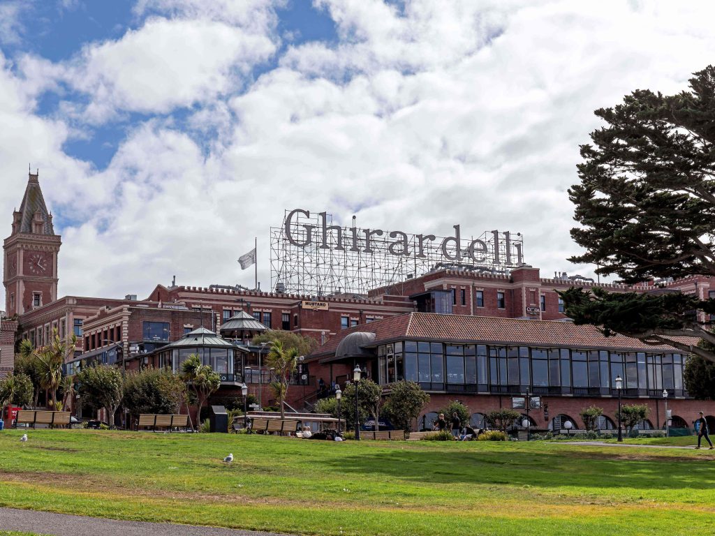Vibrant San Francisco Ghirardelli Square rooftop sign red brick buildings clock tower wallpaper
