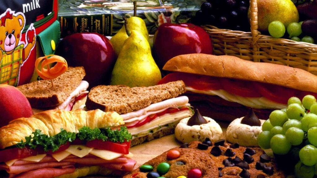 Vibrant Wallpaper of Fresh Sandwiches, Fruits & Cookies Feast