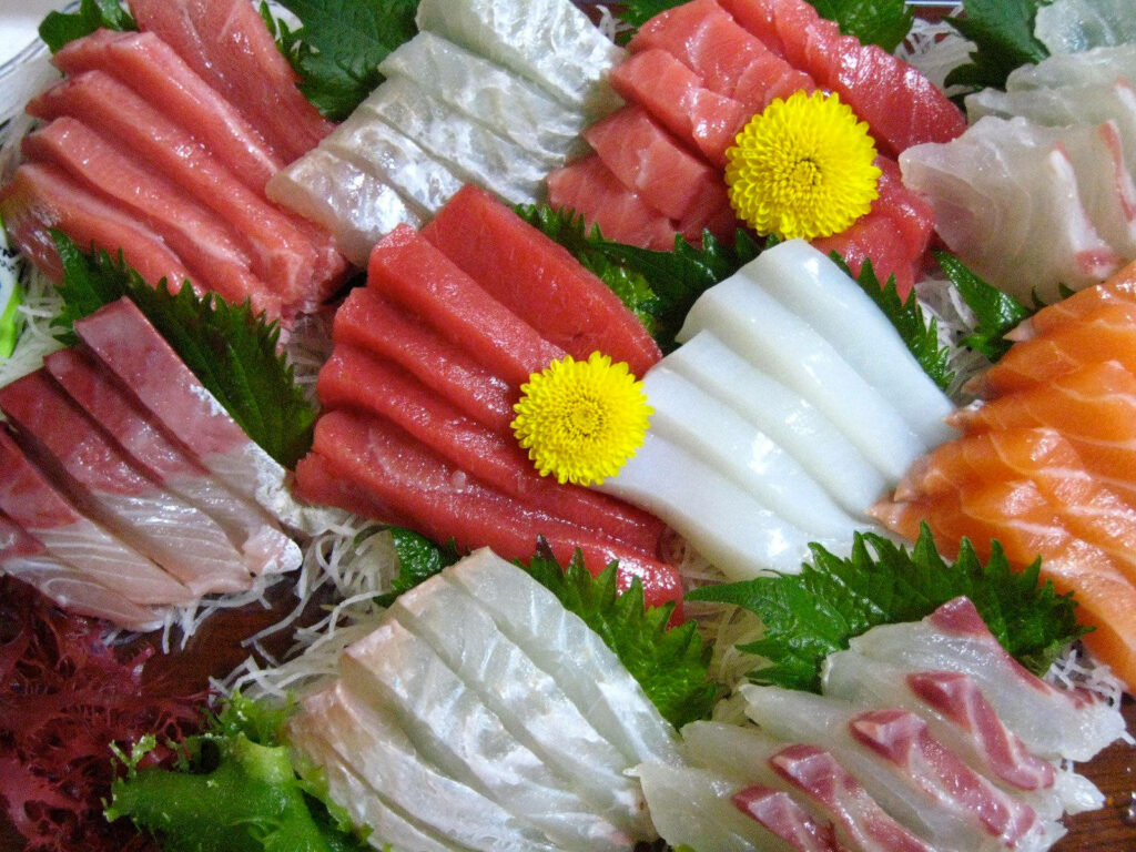Vibrant Sashimi Platter: Tuna, Salmon & Mackerel with Garnishes Wallpaper