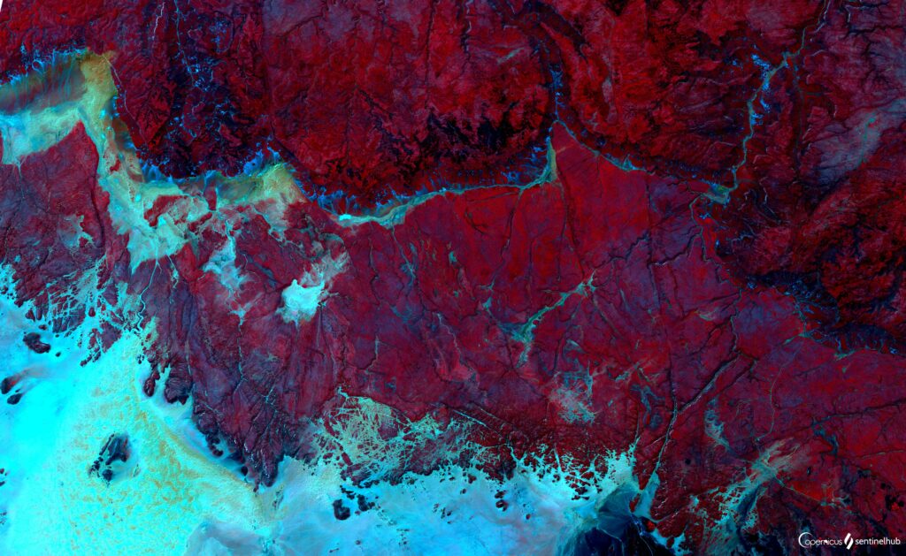 Vibrant Satellite View Wallpaper: Surreal Red & Blue Planetary Scene