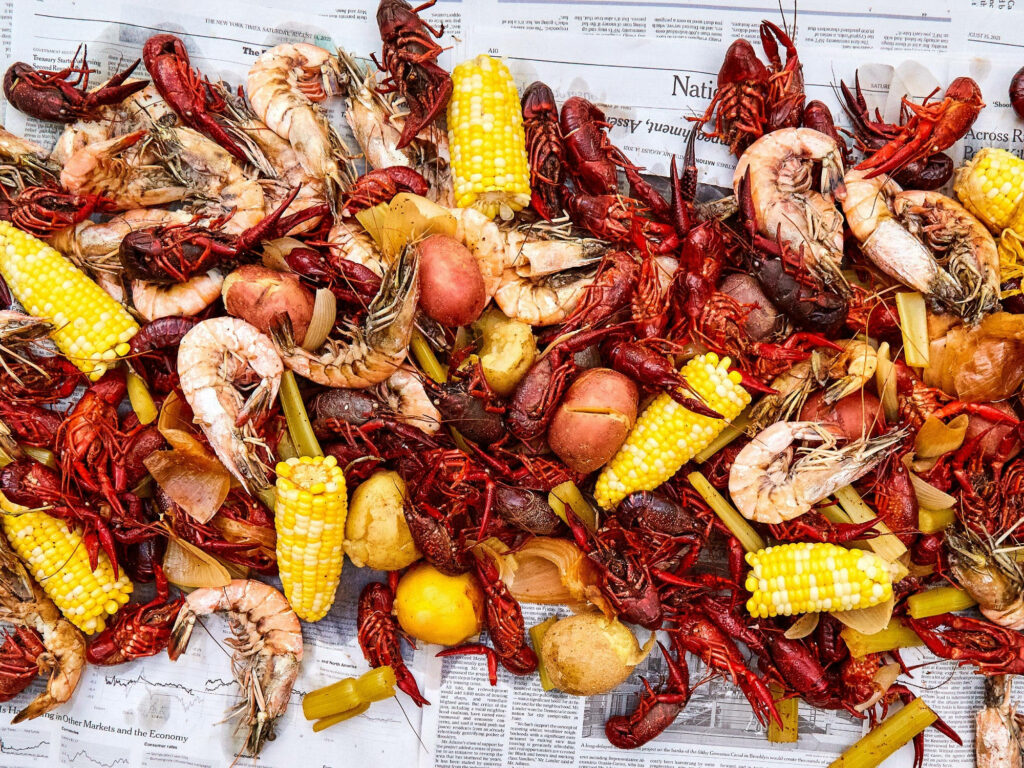 Colorful Seafood Leftovers Wallpaper: Crawfish, Shrimp & Corn Spread