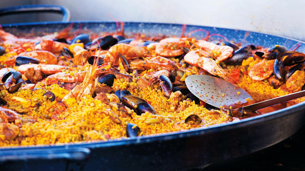 Vibrant Seafood Paella: Saffron Rice & Fresh Shrimp Wallpaper