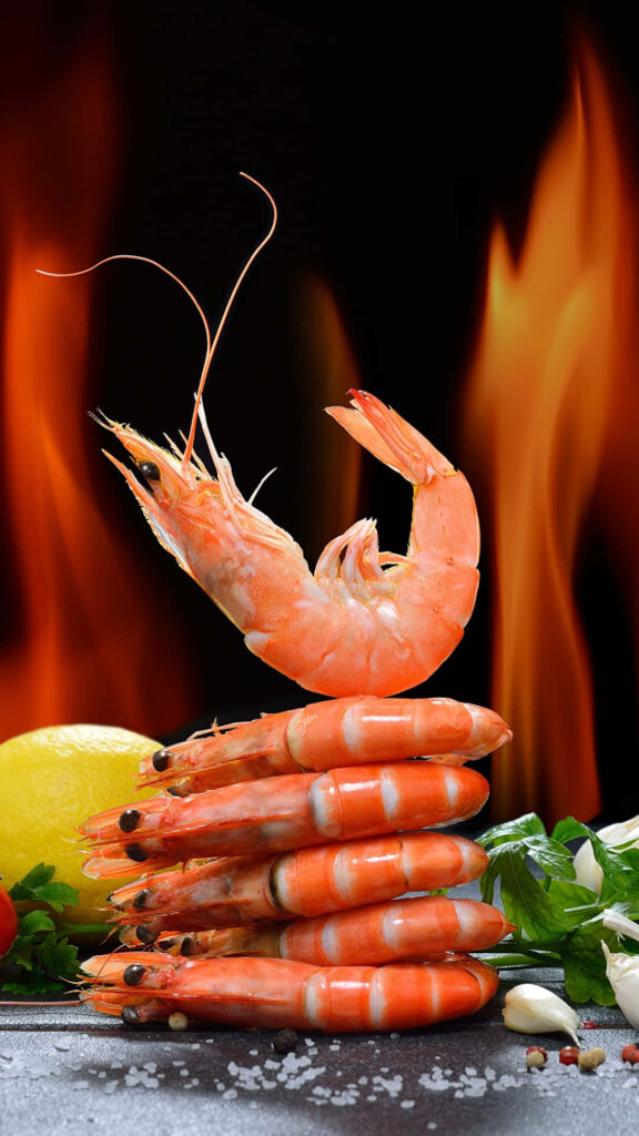 Vibrant Wallpaper: Cooked Shrimp with Fresh Ingredients on Fiery Background