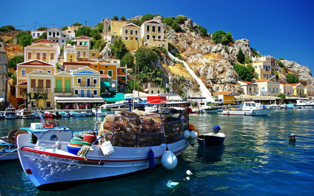Vibrant Simi Greece Wallpaper: Boats, Calm Waters & Charming Houses