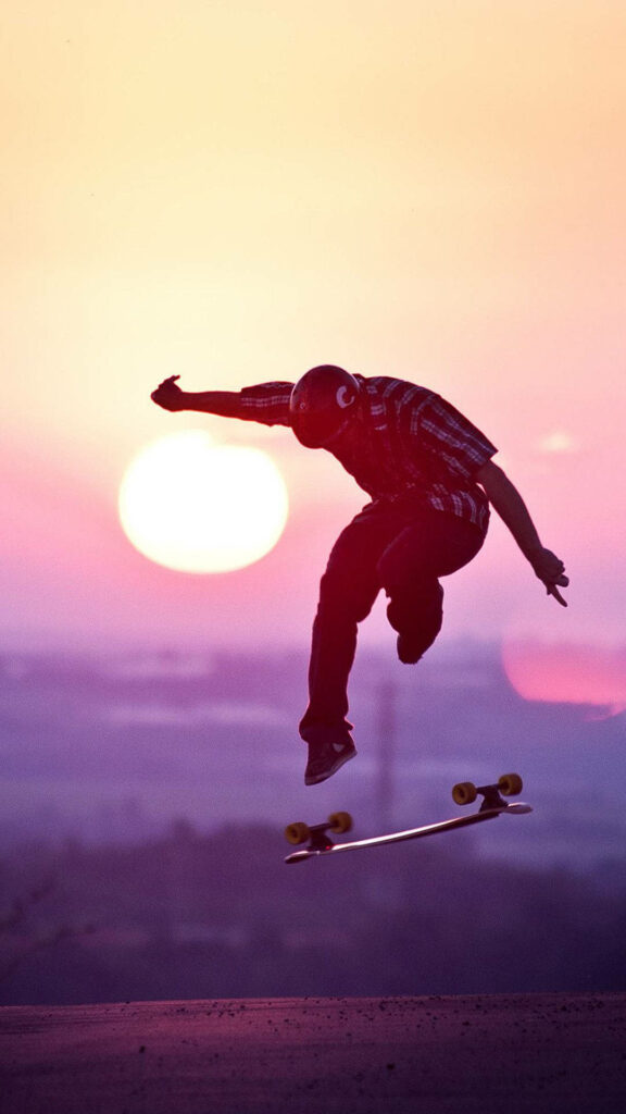 Stunning Skateboarder iPhone Wallpaper: Vibrant Sunset Background