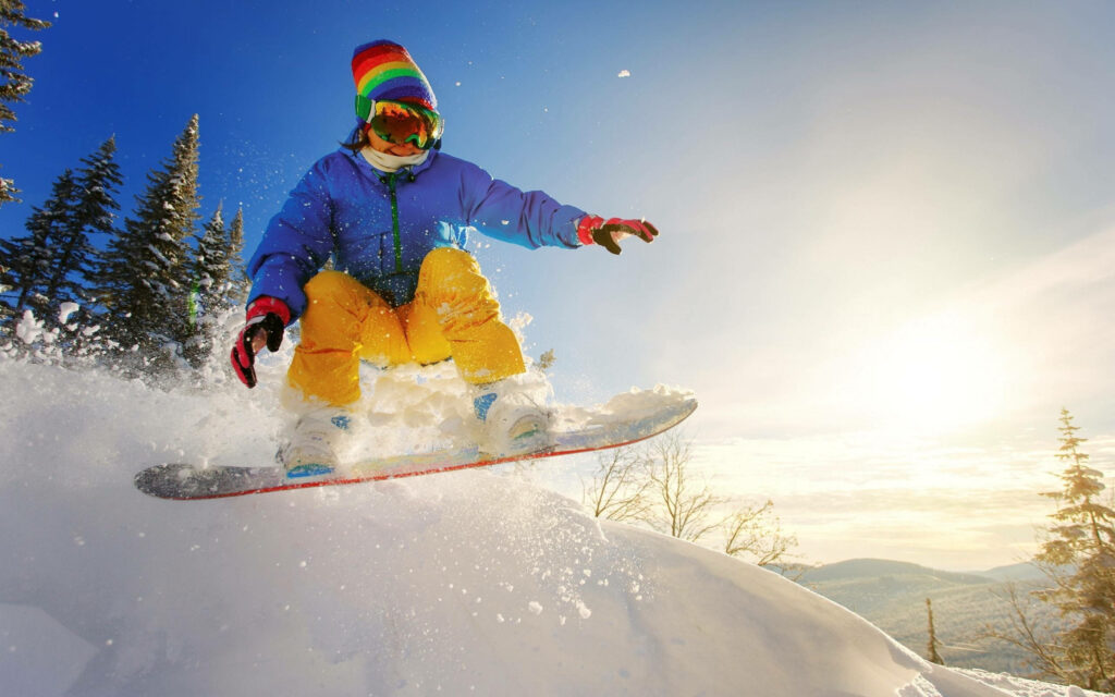 Thrilling Snowboarding Wallpaper: Aerial Stunt in Stunning Winter Scenery