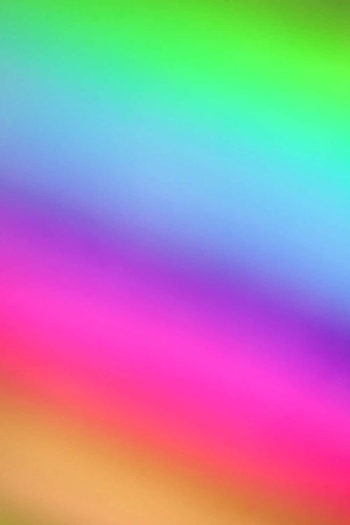 Vibrant soft rainbow gradient wallpaper with glowing green to sunset tones for iPhone display