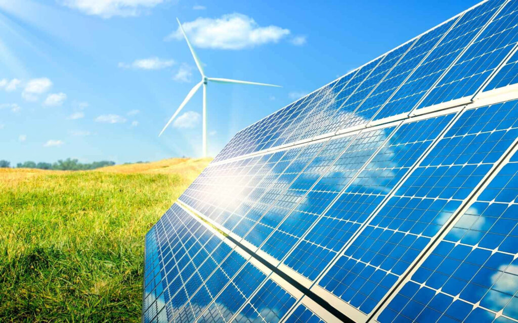Vibrant Wallpaper: Sunlit Solar Panels & Wind Turbine in Green Landscape