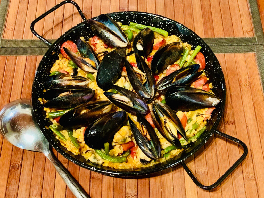 Vibrant Spanish Paella Wallpaper: Fresh Ingredients on Bamboo Mat