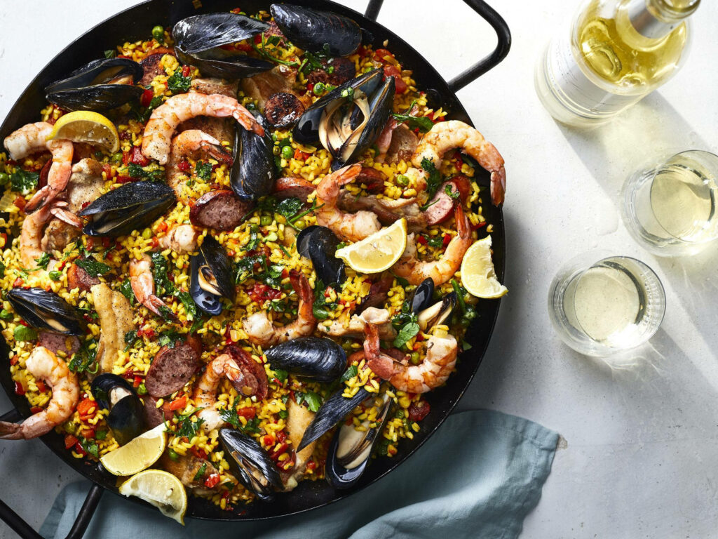 Vibrant Spanish Paella Wallpaper with Fresh Seafood & Colorful Veggies