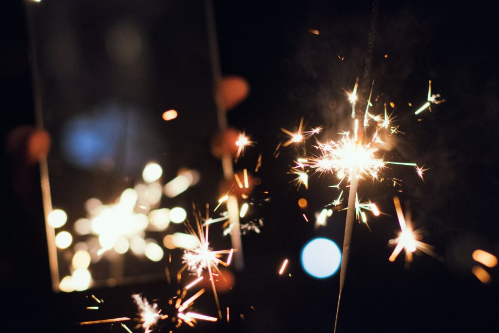Vibrant Sparkler Glow Wallpaper - Festive Background Image