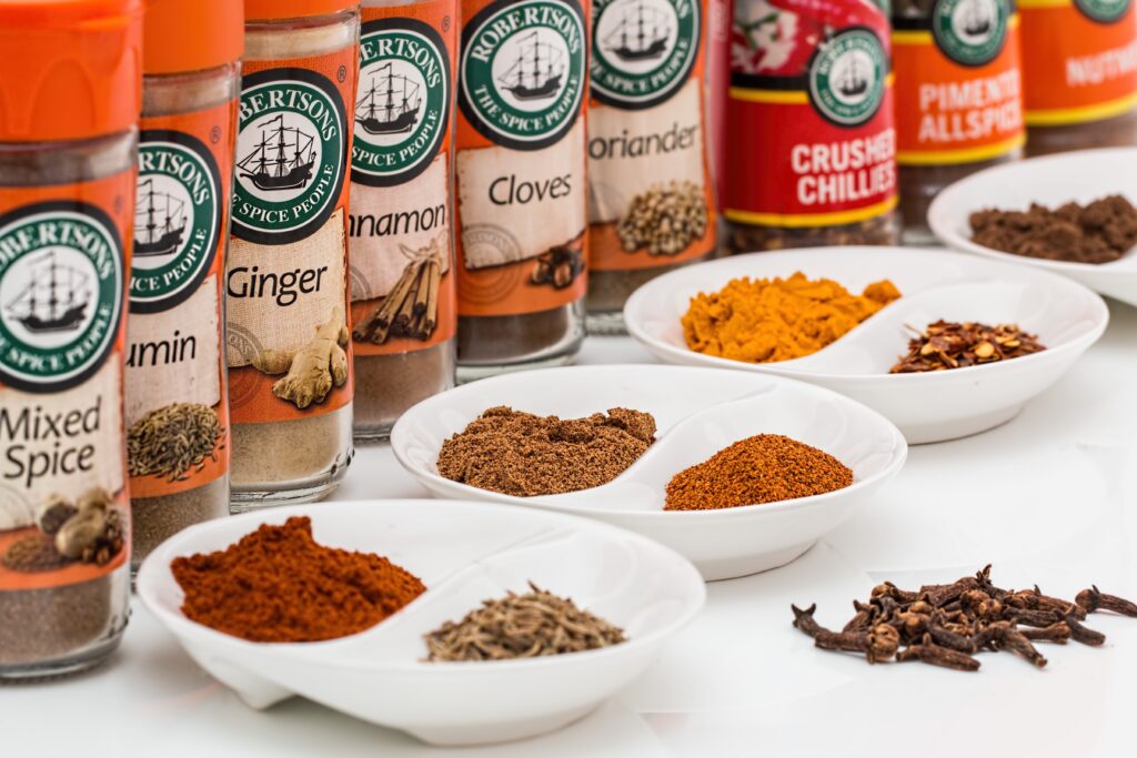 Vibrant Spice Wallpaper: Cinnamon, Cumin, and More in Beautiful Jars