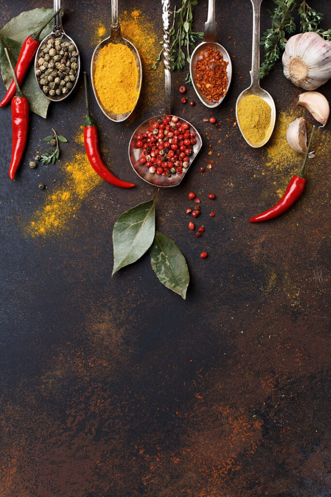 Vibrant Spice Wallpaper: Colorful Chilli & Herbs on Rustic Background