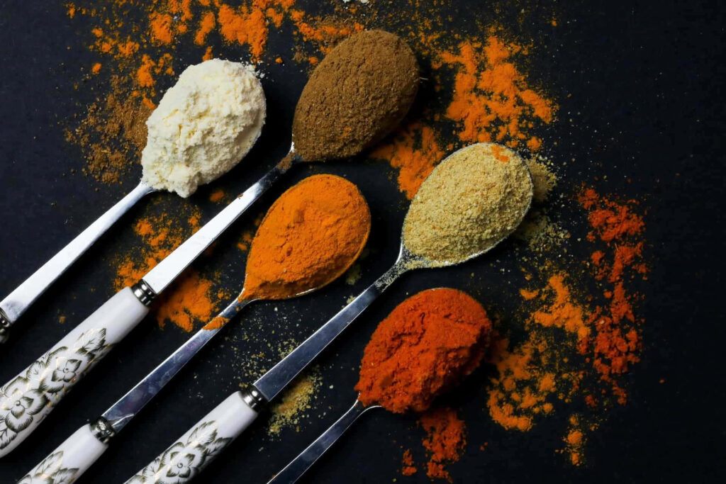 Vibrant Spice Wallpaper: Five Silver Spoons and Colorful Spices