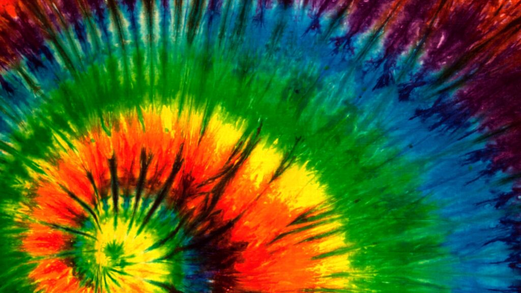 Vibrant spiral tie dye wallpaper with vivid green yellow red blue and purple psychedelic hues