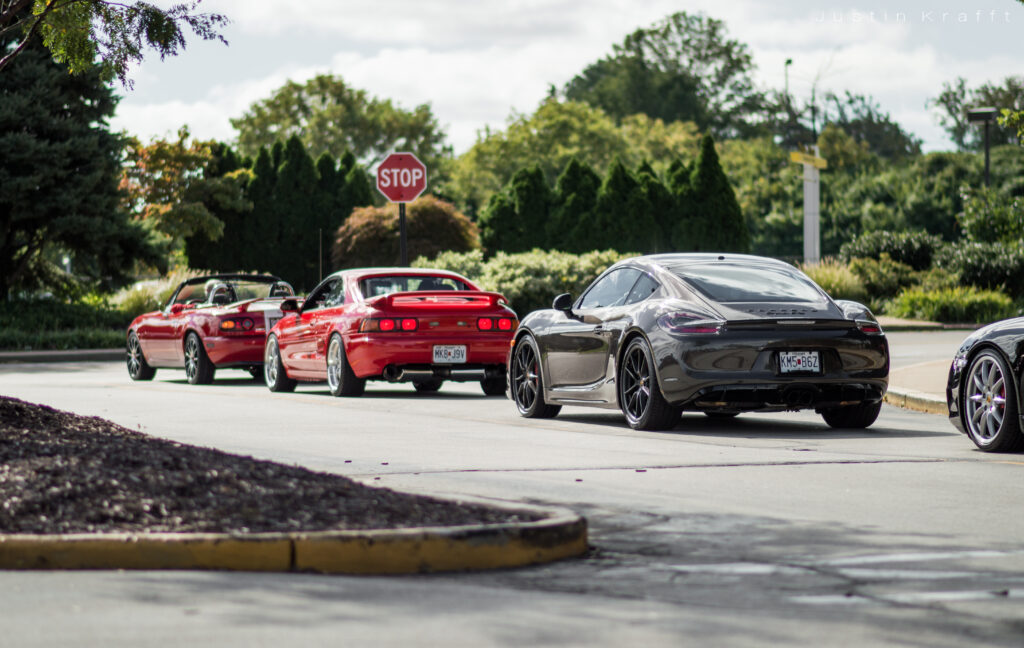 Modern Sports Cars in Scenic Outdoor Setting - Vibrant Wallpaper