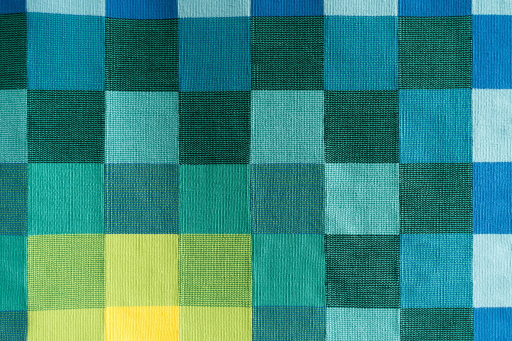 Vibrant Geometric Harmony: Multicolored Checkered Tapestry Unleashing Yellow and Green Brilliance as a Captivating 4K Wallpaper Background