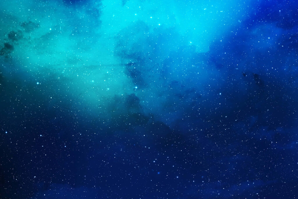 Vibrant starry nebula wallpaper with deep blues and glowing turquoise hues.