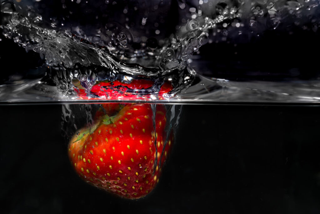 Vibrant Strawberry Splash: Detailed Red Close-Up Wallpaper Background