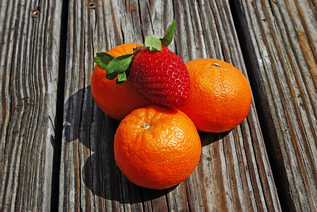 Fresh Strawberry & Juicy Tangerines Wallpaper on Rustic Wood