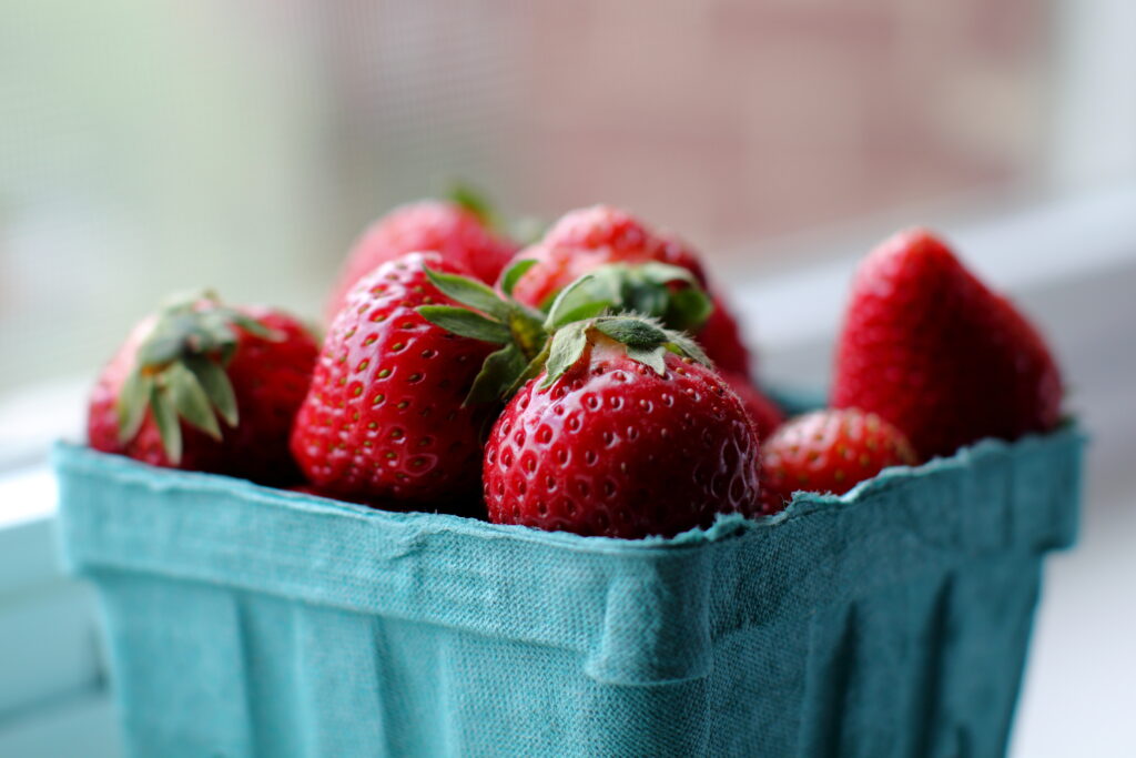 Vibrant Strawberry Wallpaper: Close-Up Freshness in a Blue Container