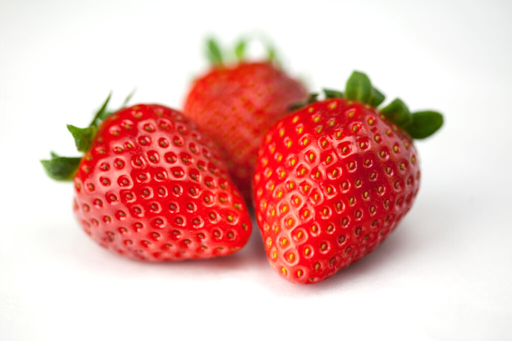 Vibrant Strawberry Wallpaper: Close-Up on Glossy Red Surfaces