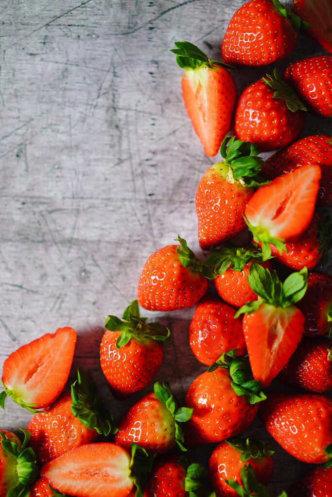Vibrant Strawberry Wallpaper: Ripe Fruits on Textured Background