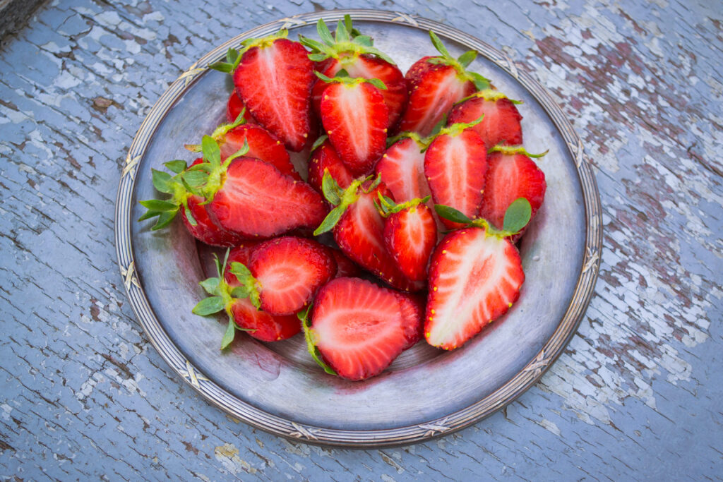 Vibrant Strawberry Wallpaper: Fresh, Whole & Sliced on Rustic Plate