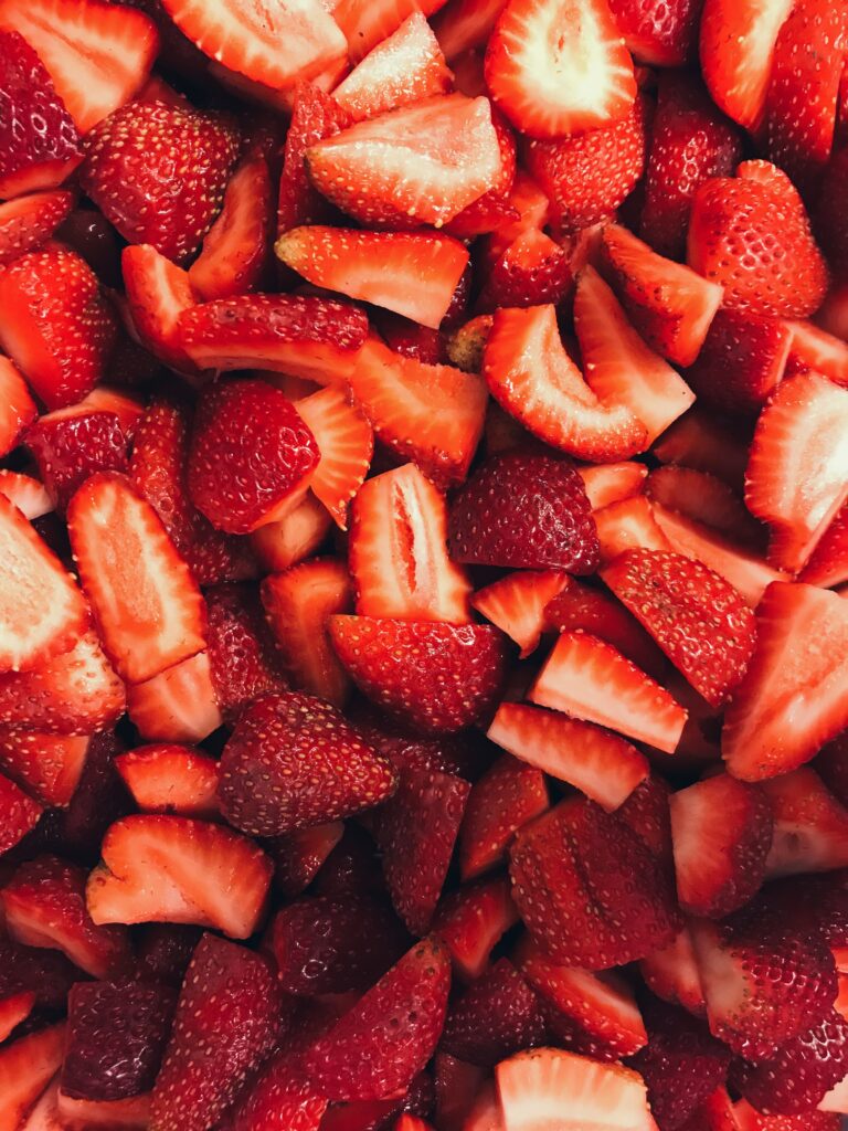Vibrant Wallpaper of Juicy Sliced Ripe Red Strawberries Background