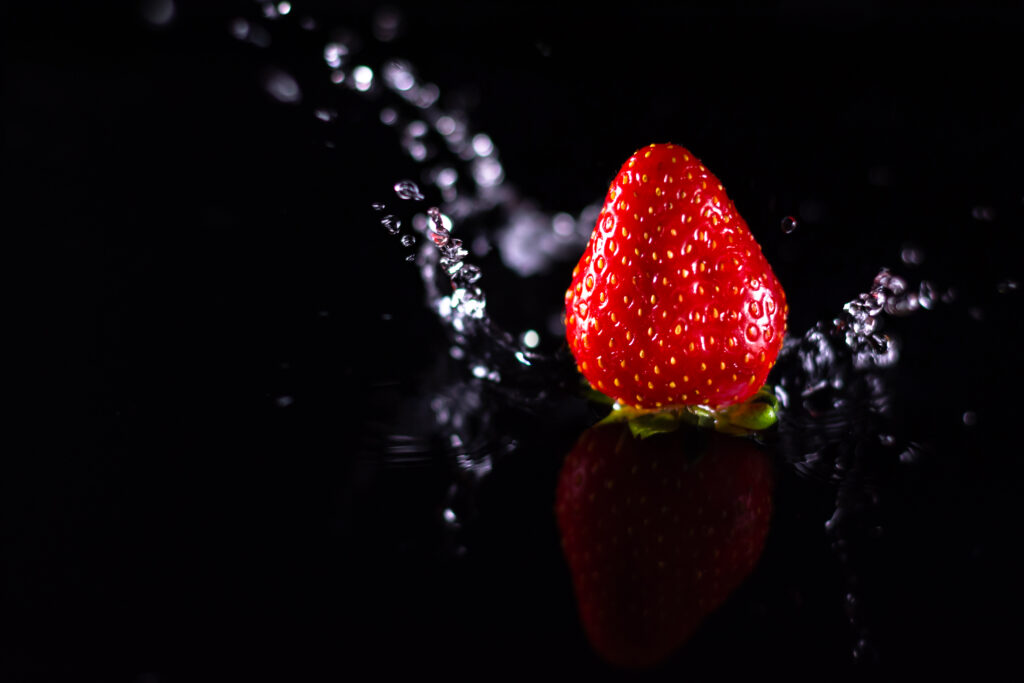 Vibrant Strawberry Wallpaper: Reflections & Water Droplets Background