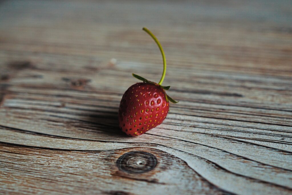 Vibrant Strawberry Wallpaper: Rustic Wood Texture Background