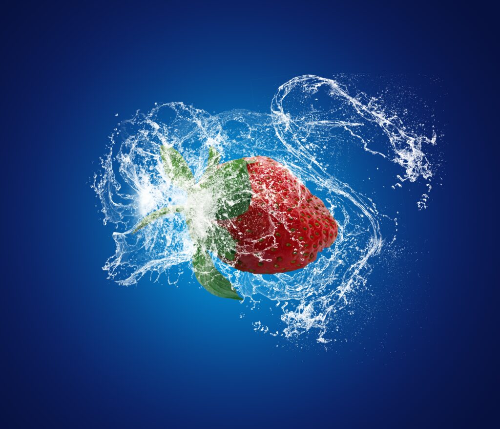 Vibrant Strawberry Wallpaper: Dynamic Water Splashes on Blue Background
